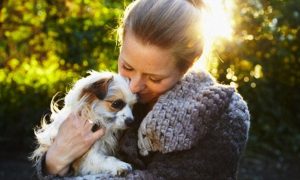 Woman cuddling pet